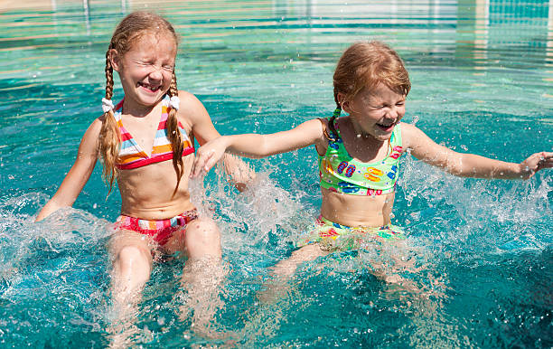istock two little girls in the pool 177444437