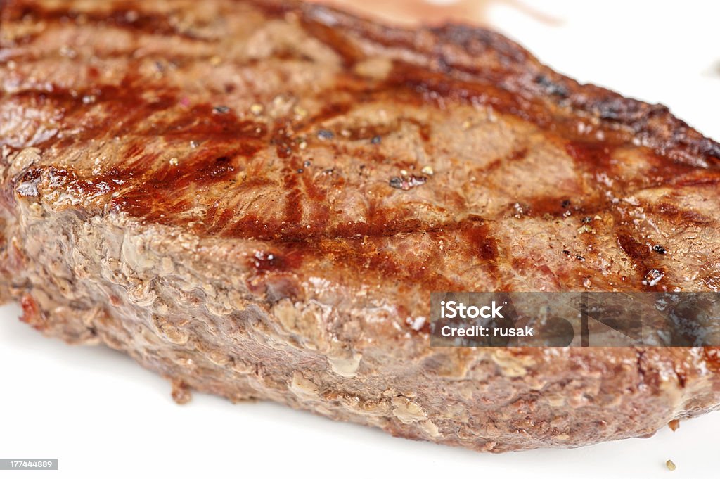 Juicy rib-eye beef steak Juicy rib-eye beef steak on a white plate Barbecue - Meal Stock Photo