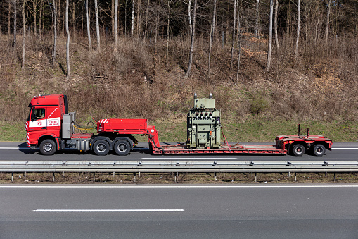 Wiehl, Germany - March 24, 2021: Colonia Mercedes-Benz Actros truck with flatbed trailer on motorway