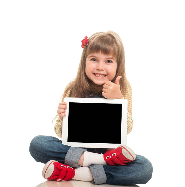 istock little girl sitting on the floor with tablet computer 177445512
