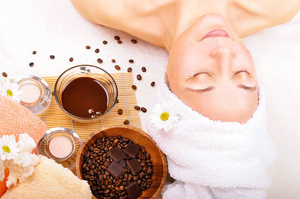 beautiful older woman "beautiful older woman, near the coffee. candles, towels and other accessories." sponge bath sponge nature animal stock pictures, royalty-free photos & images