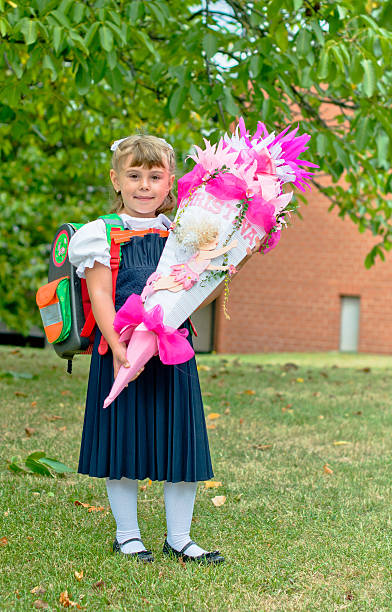 Child holding gift school coneMore of this theme at: