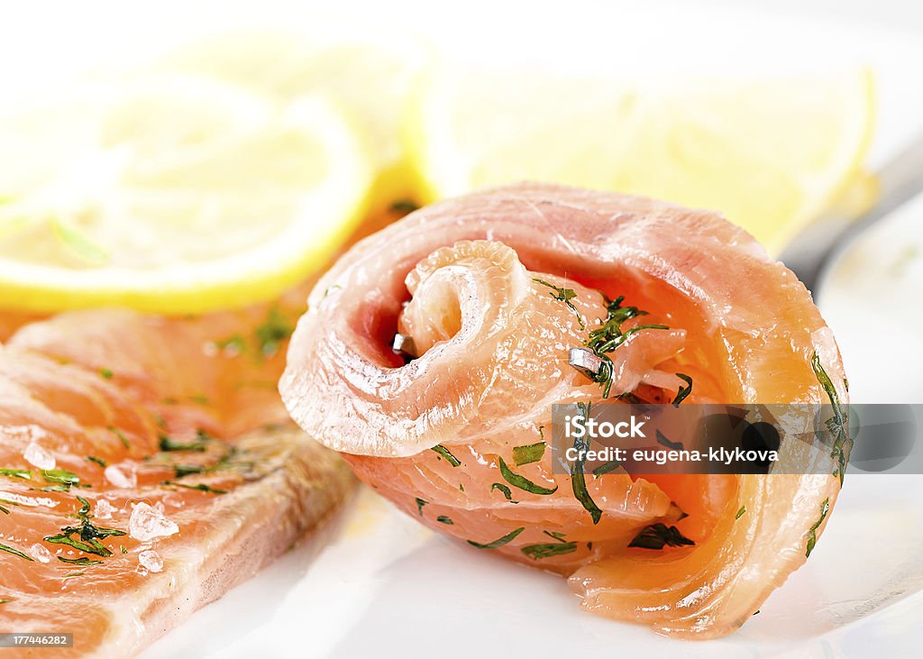slices of salted salmon with lemon on white slices of curried salmon and lemon on white Appetizer Stock Photo
