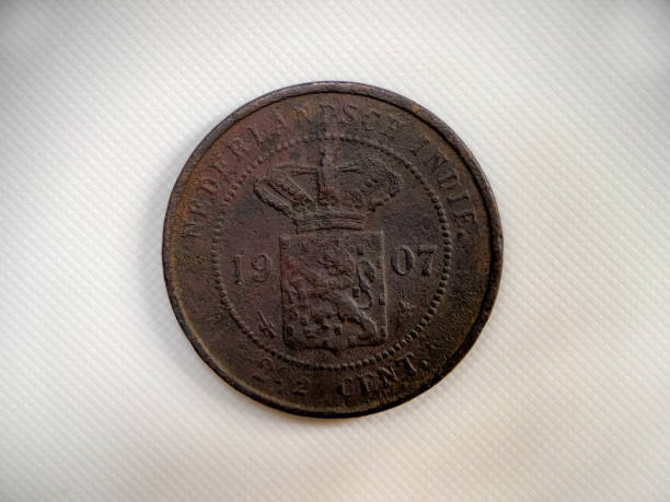 Ancient Indonesian coins on a white background.