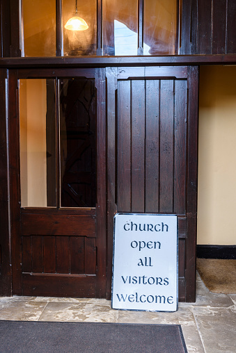 Sign at the entrance to a church advising people that the church is open and visitors are welcome