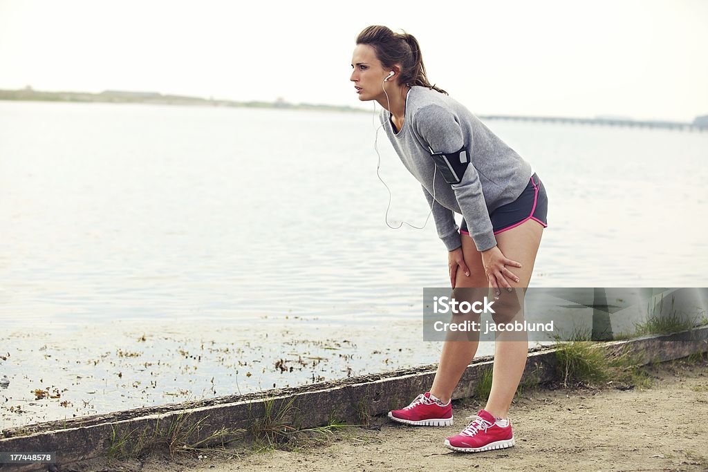 Woman Resting After Running Female taking a break after running Athlete Stock Photo