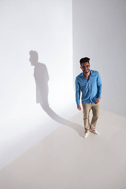 istock casual man smiles while looking up at you 177448715