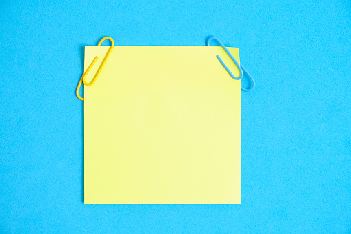 Yellow paper stickers for writing notes on a blue background