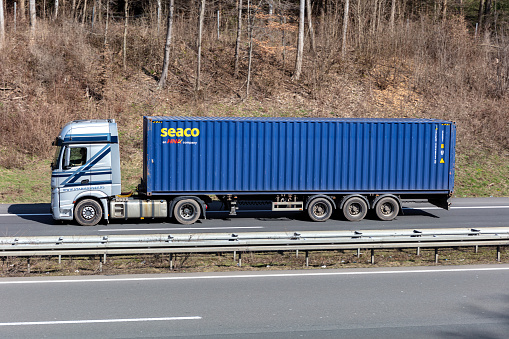 Wiehl, Germany - March 24, 2021: Starmans Mercedes-Benz Actros truck with seaco container on motorway