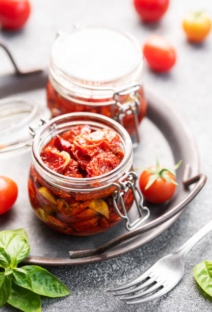 istock Jars with sun dried tomatoes with fresh herbs and spices. 1774491374