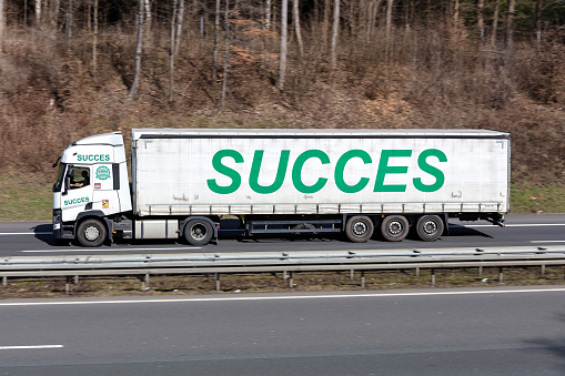 Wiehl, Germany - March 24, 2021: Succes Renault truck with tarpaulin trailer on motorway