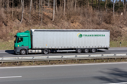 Wiehl, Germany - March 24, 2021: Transimeksa Mercedes-Benz Actros truck with curtainside trailer on motorway