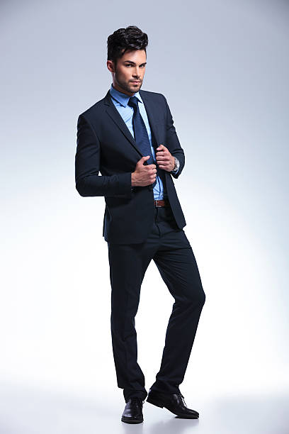 istock business man stands with hands on jacket 177450688