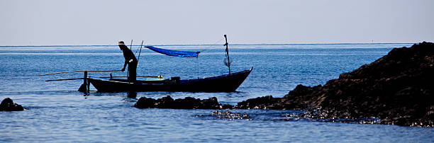 istock Fisherman and old boat 177451526