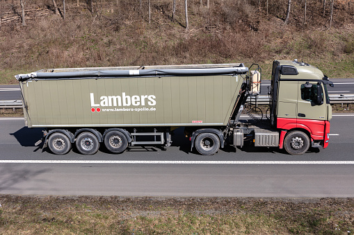 Wiehl, Germany - March 24, 2021: Lambers Mercedes-Benz truck with tipper trailer on motorway