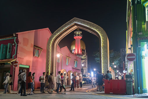 Bugis, Singapore - ââOctober 13, 2023: Muslim people at gate entrance of Sultan Masjid church at night in Haji Lane. famous travel destination in Arab area.