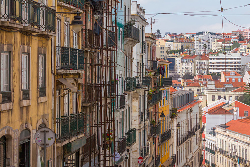 Street perspective view with colorful traditional houses. Lisbon, Portugal.