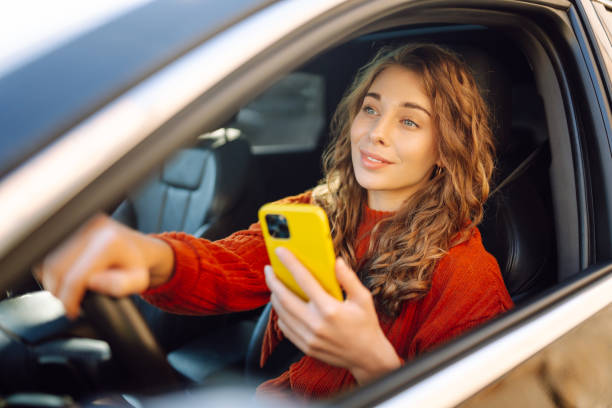 istock A woman driver uses a smartphone in the car. 1774540267