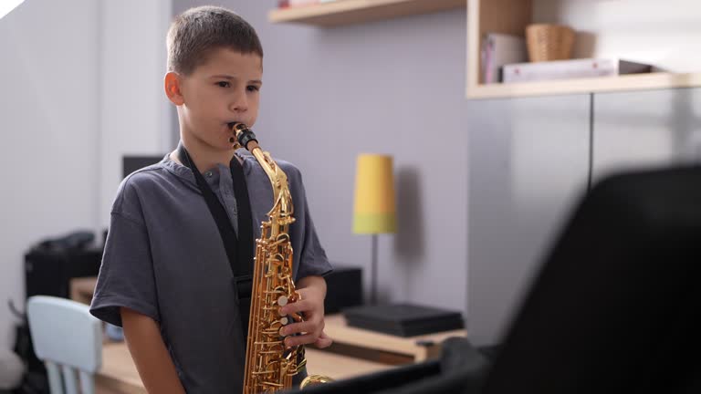 Little musician playing saxophone