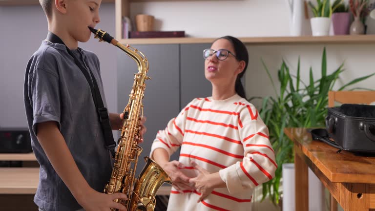 Boy saxophonist with teacher