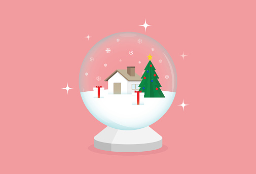 House, Christmas tree, and Christmas present in a snow globe for the magic of Christmas concept and winter celebration