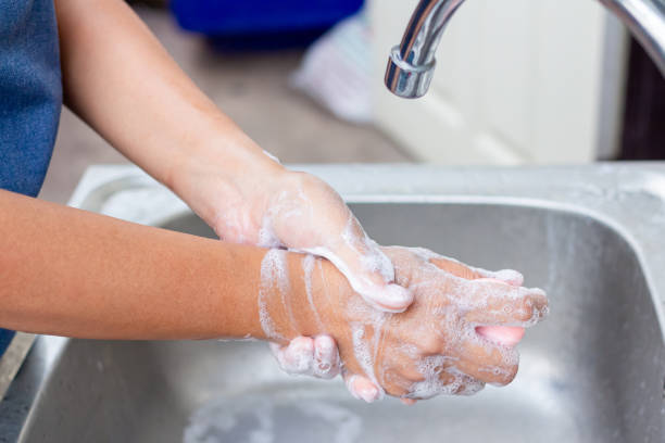 istock Young woman washing hands with soap over sink 1774544779