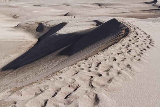 Gigantic sand dunes rising to more than 700 ft, 213 metres