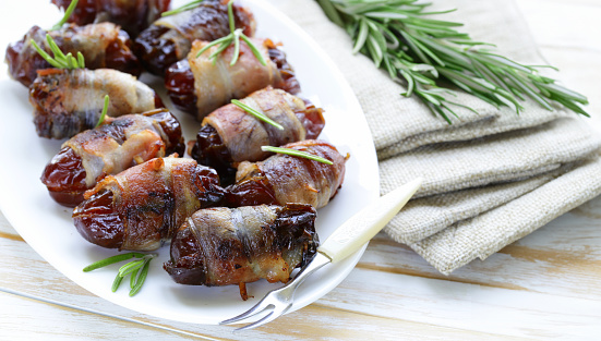 delicacy appetizer fried dates with bacon and rosemary