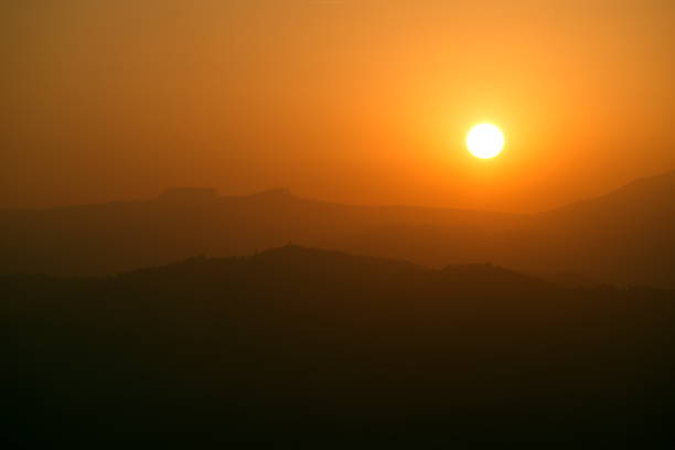 istock view of the hills and the setting sun 1774548098