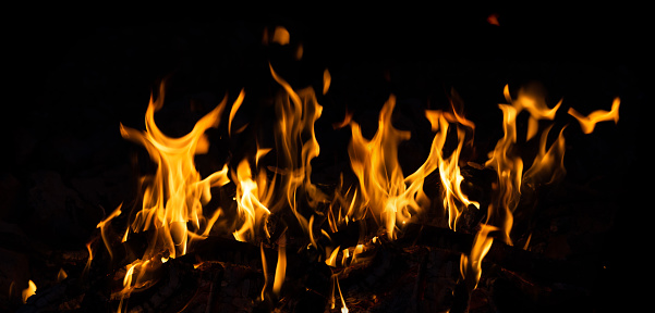 Raging flames of intense fire with no reflection over black background