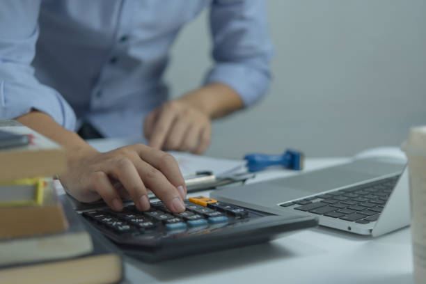 istock Businessman using calculator and accounting documents at desk with laptop computer. 1774553060
