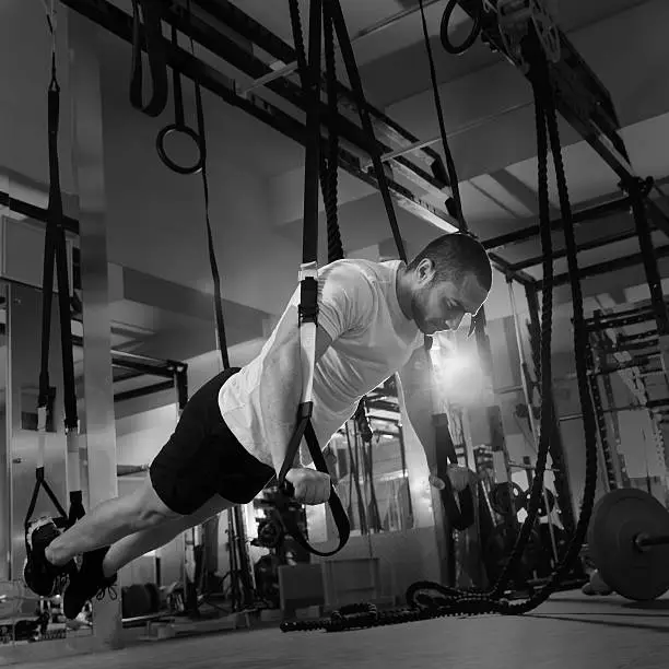 Photo of gym fitness TRX push ups man workout