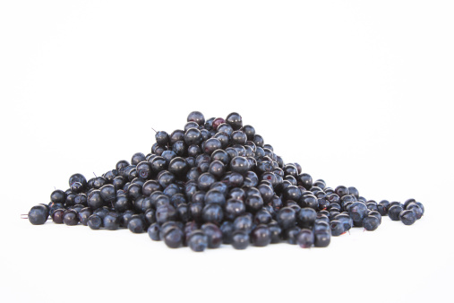 Blueberries in a pile on white background.
