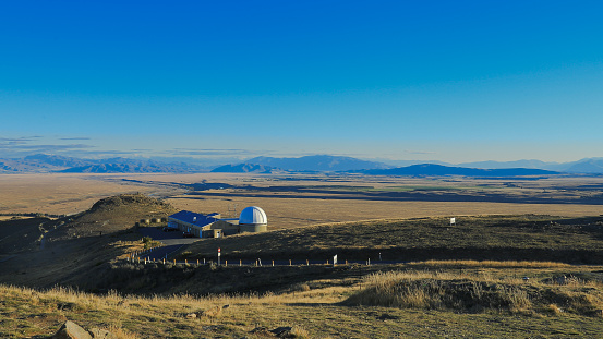 Beautiful blue sky with mountain range, Mount John observatory, south island, New Zealand. On the top of Mount John with scenic of lake Tekapo and lake alexandrina in turquoise.