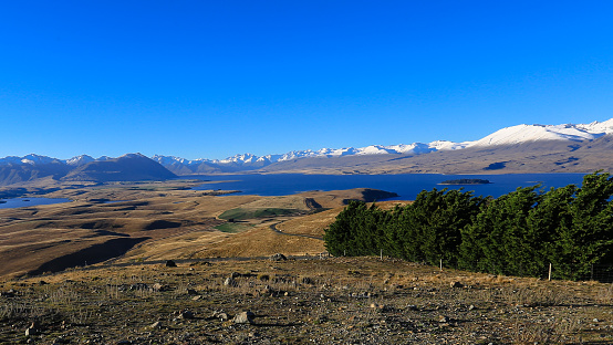 Beautiful blue sky with mountain range, Mount John observatory, south island, New Zealand. On the top of Mount John with scenic of lake Tekapo and lake alexandrina in turquoise.