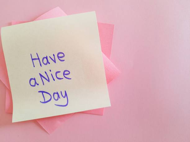 istock Message written on a yellow sticky note,'Have a nice day', attached to pink sticky notes on blank sheet of pink paper with copy space 1774596375