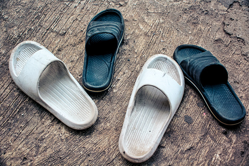 Two pairs of black and white sandals
