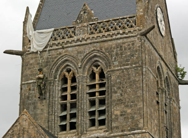 DDAY Memorial with us Paratrooper on the bell tower Sainte-Mere-Eglise, FRA, France - August 21, 2022: DDAY Memorial with american Paratrooper on the bell tower sentinel spire stock pictures, royalty-free photos & images