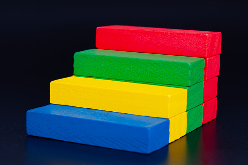 Front view of stacking colorful wooden blocks with customizable space for text.