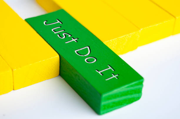 istock Just do it text on green wooden block. Motivational concept. 1774603036