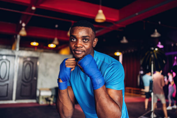 istock Boxer training in Boxing Club. Boxing fighters training at gym. Strong muscular Man practicing box in gym. 1774604738
