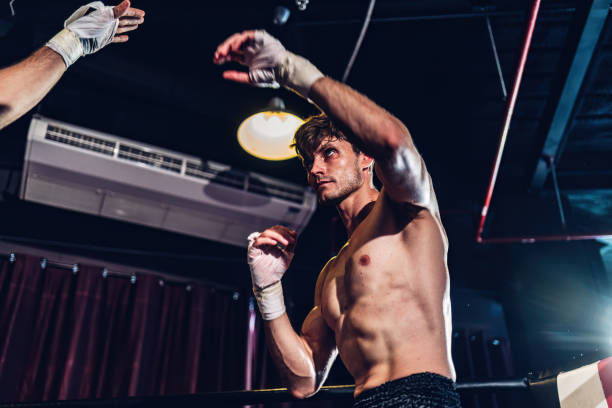 istock Boxer training in Boxing Club. Boxing fighters training at gym. Strong muscular Man practicing box in gym. 1774604790