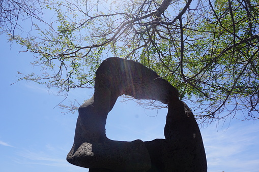 A strange natural rock sculpture with a hole in front of