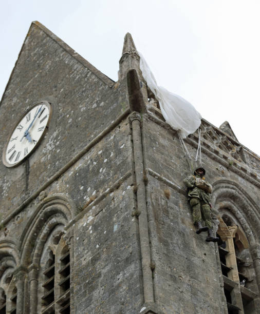 DDAY Memorial with Paratrooper on bell tower Sainte-Mere-Eglise, FRA, France - August 21, 2022: DDAY Memorial with American Paratrooper on the bell tower sentinel spire stock pictures, royalty-free photos & images