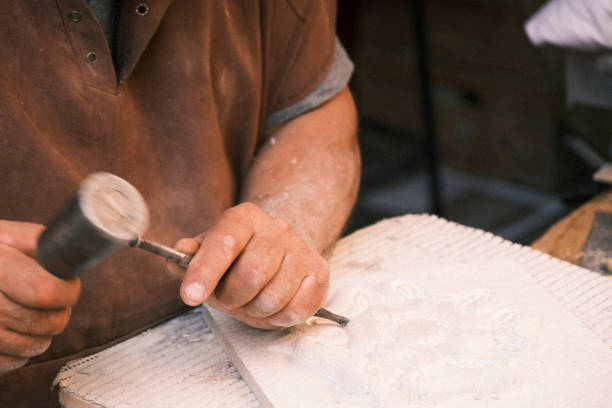 istock Stone carver shaping a piece of stone 1774635673