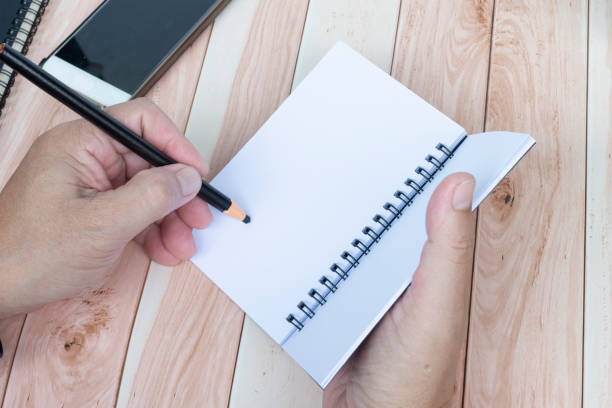 istock Businessman hands with pen writing notebook on office desk. Copy space. 1774649715
