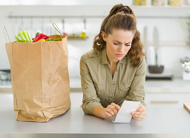 istock Concerned housewife checking bill after shopping in kitchen 177466480