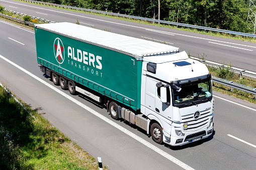 Wiehl, Germany - June 26, 2020: Alders Mercedes-Benz Actros truck with curtainside trailer on motorway