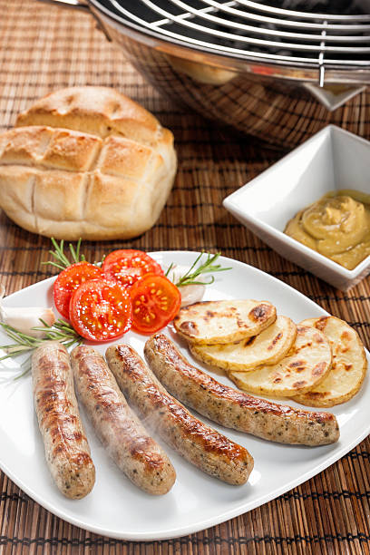 Smoking hot nuremberg sausages or Bratwurst on plate. stock photo