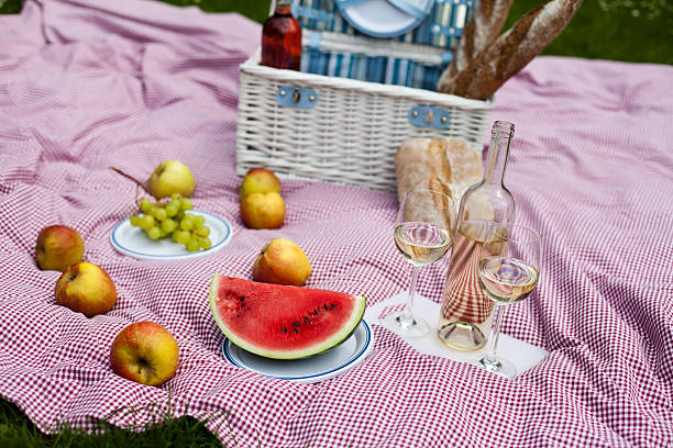istock Wine and picnic basket on the grass 177471467